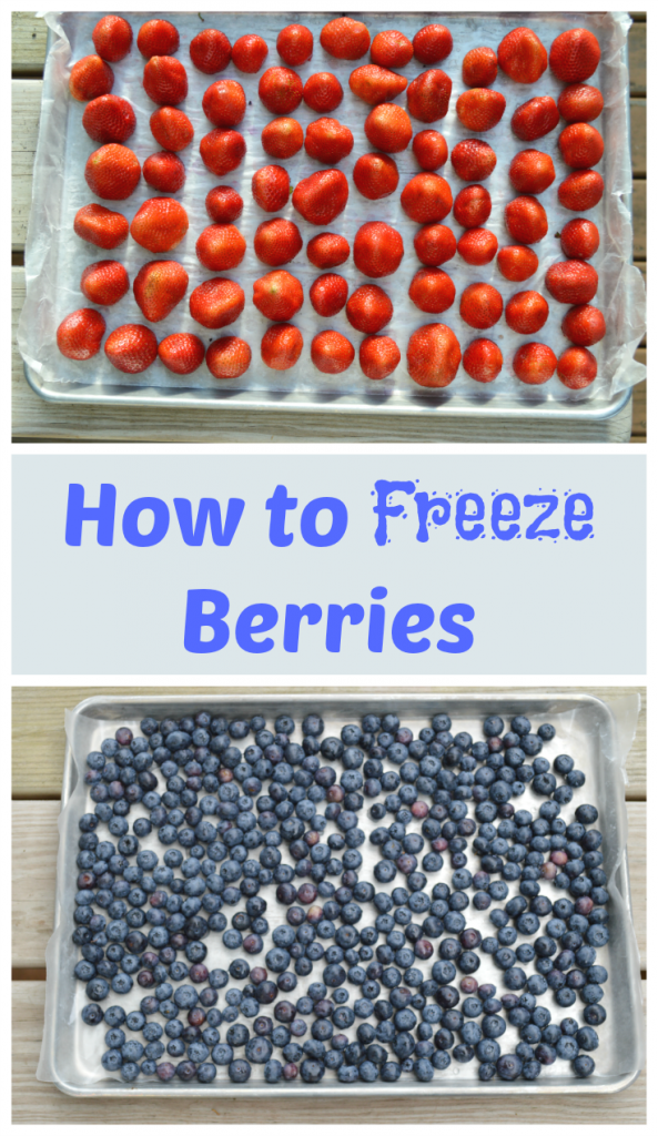 Tray of strawberries and blueberries on wax paper ready for the freezer.