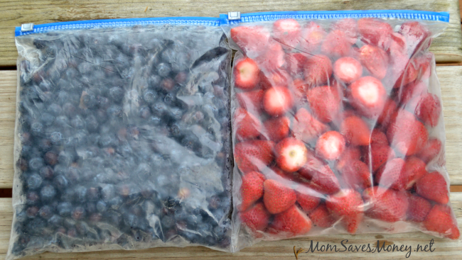 2 freezer bags - one with individually frozen blueberries and one with frozen strawberries