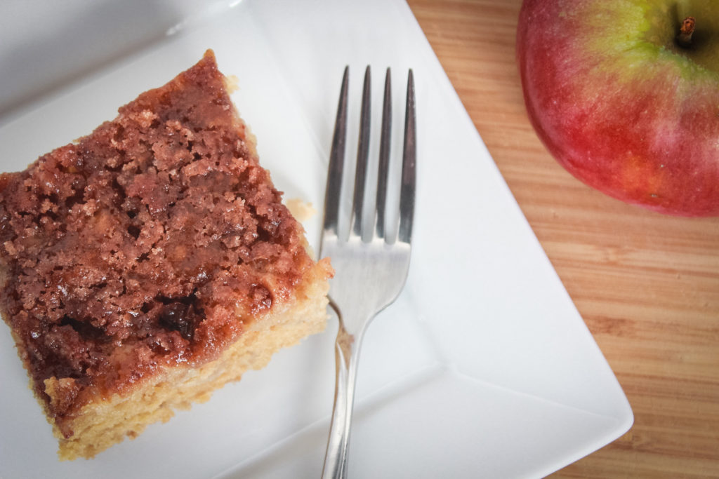 apple cake plated with fork and apple