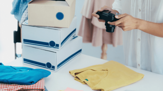 woman taking pictures of clothing to sell