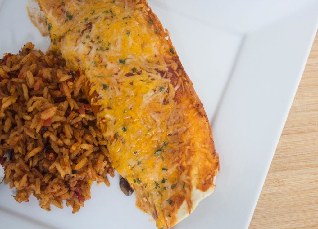 Chicken enchiladas and mexican rice plated