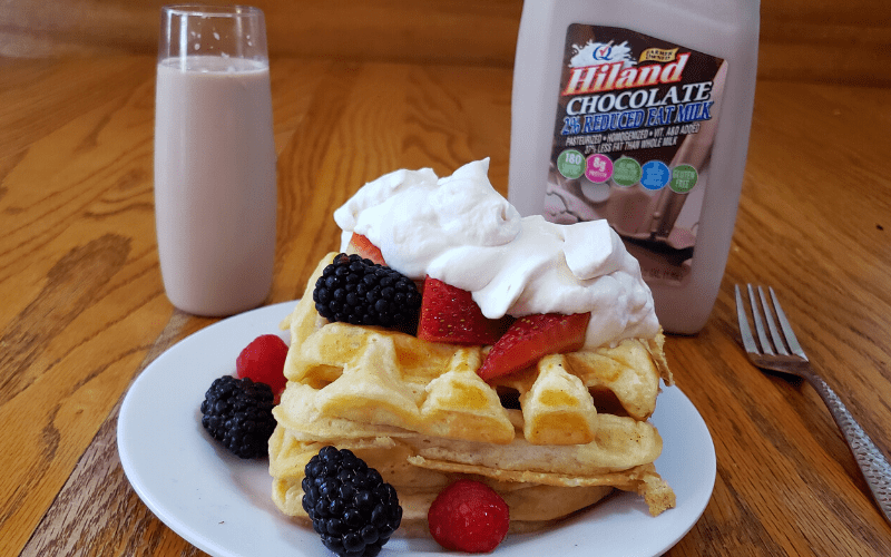 buttermilk waffles with fruit and whippng topping served with chocolate milk