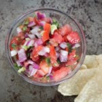 Fresh pico de gallo in glass bowl with tortilla chips