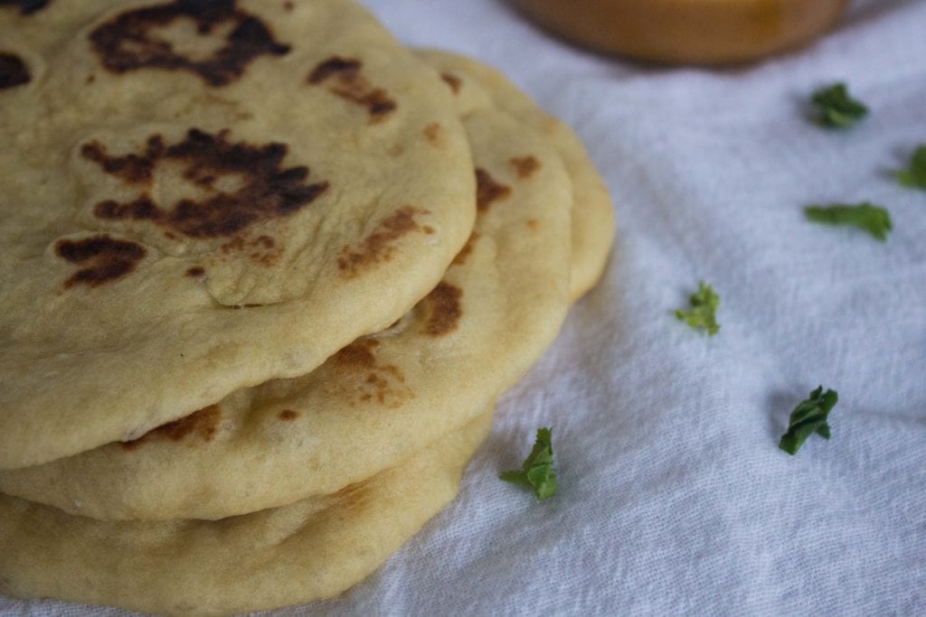 Homemade naan bread on white clothe