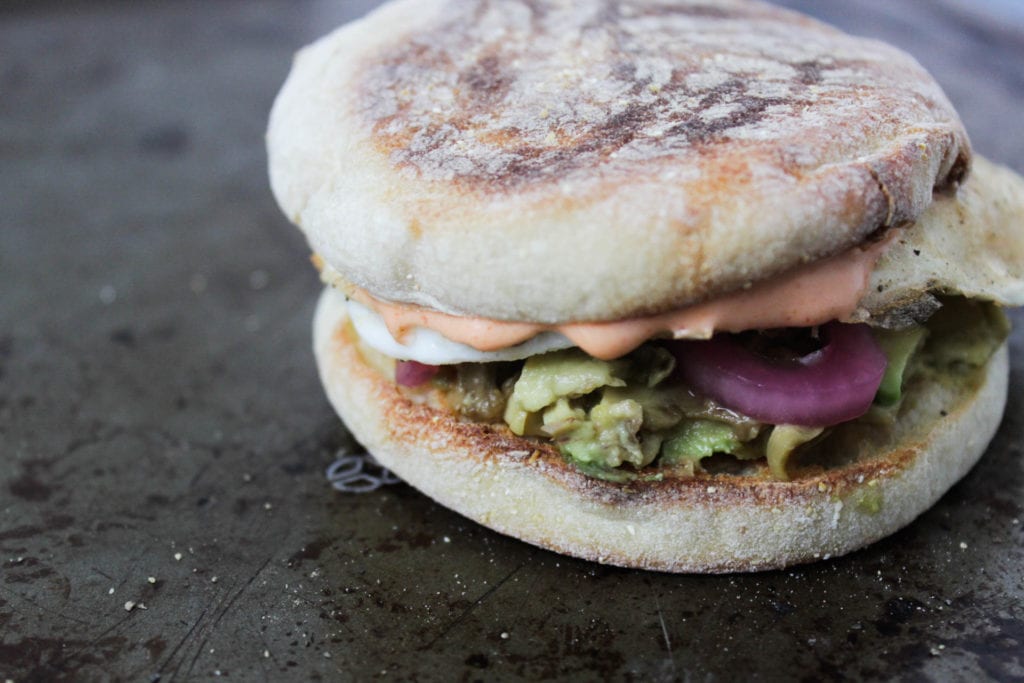 Avocado and egg breakfast sandwich on English muffin