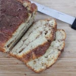 Sliced cinnamon loaf bread on cutting board with knife in background