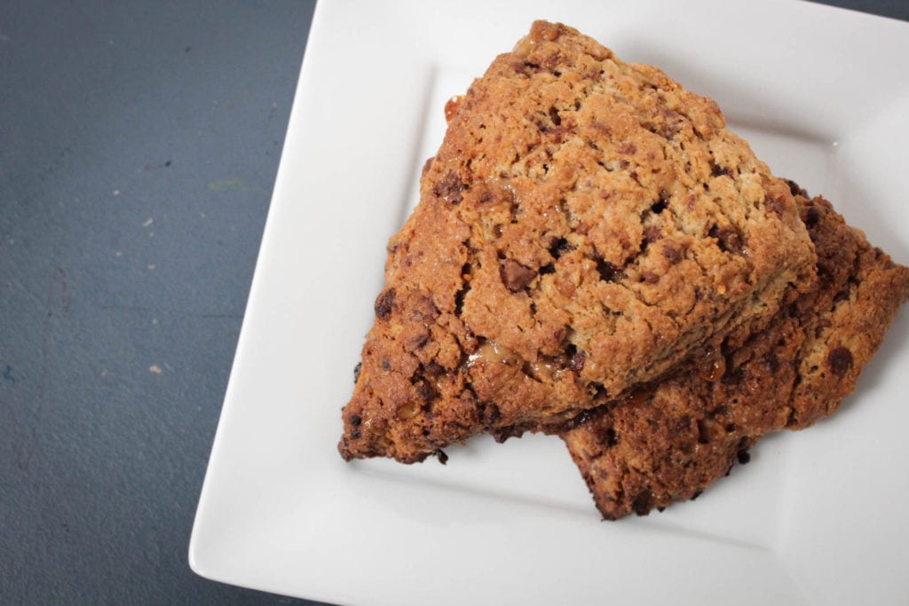 Two toffee nut scones on a white plate