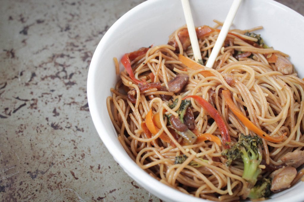 Asian noodle stir fry with carrots, red bell peppers, broccoli in a homemade sauce