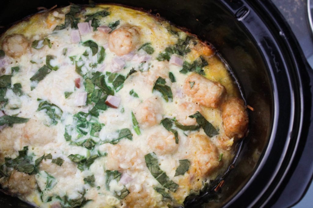 Easy egg, cheese, ham, and spinach casserole made in the crock pot