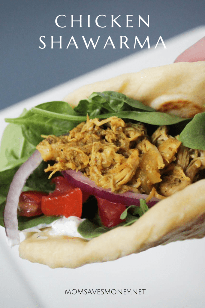 Chicken Shawarma made in the slow cooker and served on naan bread with dill sauce, greens, red onions and diced tomatoes