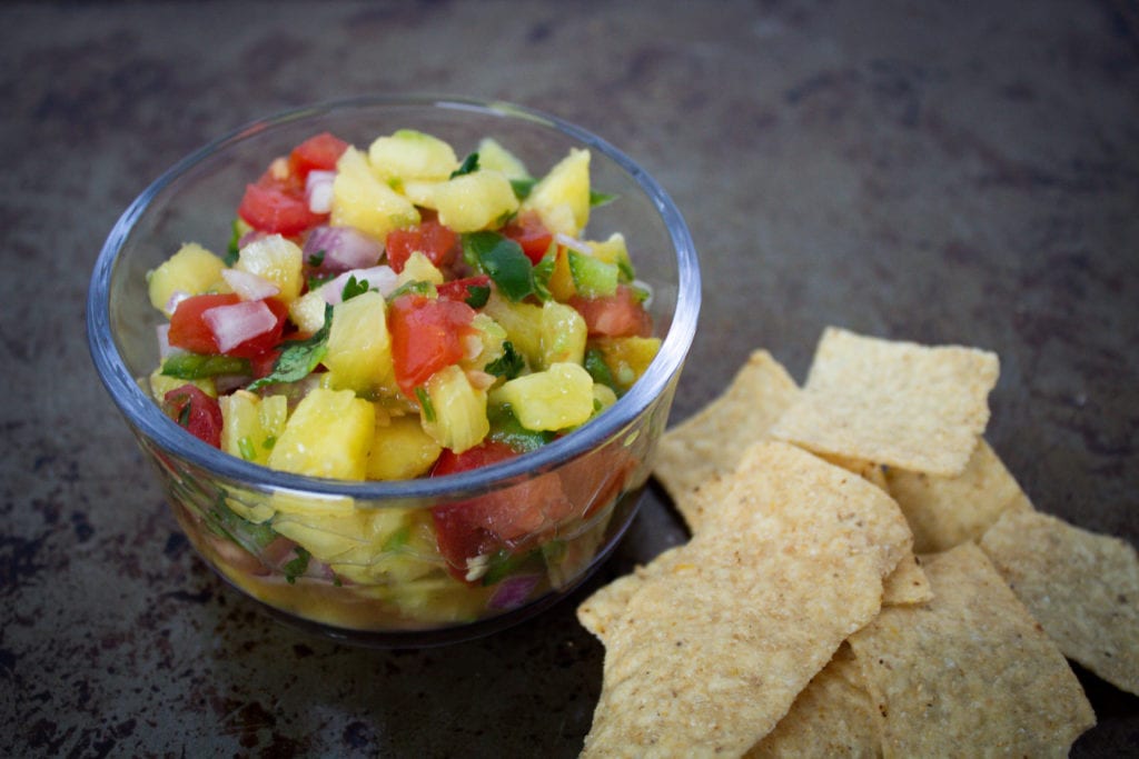 Bowl of Pineapple salsa served with tortilla chips