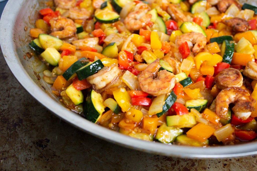 Shrimp stir fry with bell peppers, zucchini and onion in a homemade garlic sauce