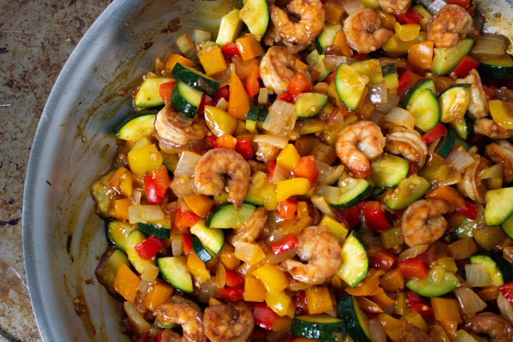 Shrimp stir fry with bell peppers, zucchini and onion in a homemade garlic sauce