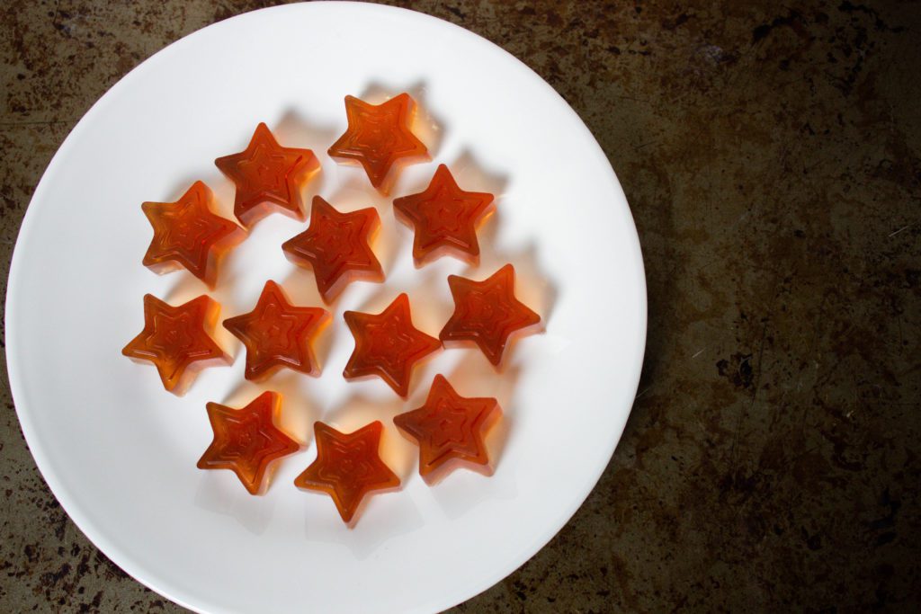 Star shapped homemade gummy candy on a white plate