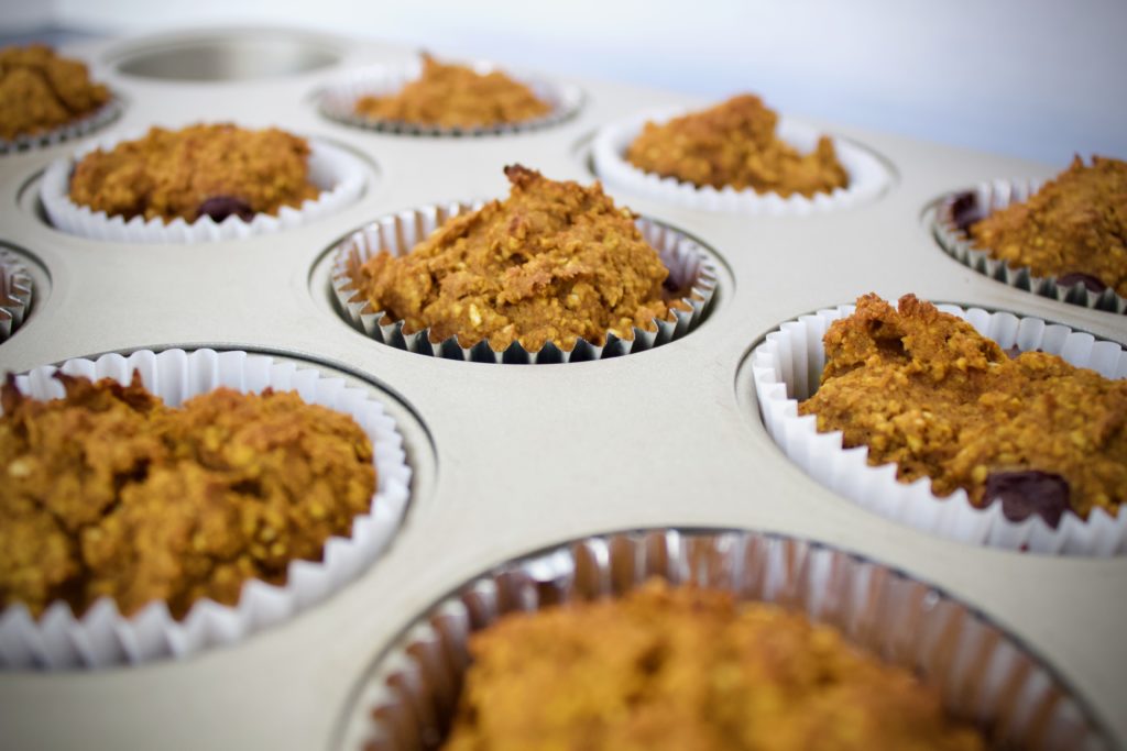 Side-view of gluten free pumpkin muffins in a muffin tin