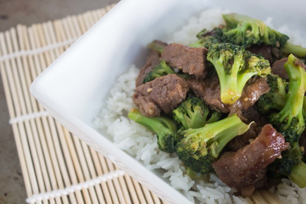 Cooked steak and broccoli with white rice in a bowl