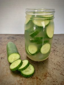 sliced pickles in glass jar