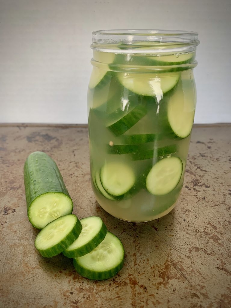 sliced pickles in glass jar