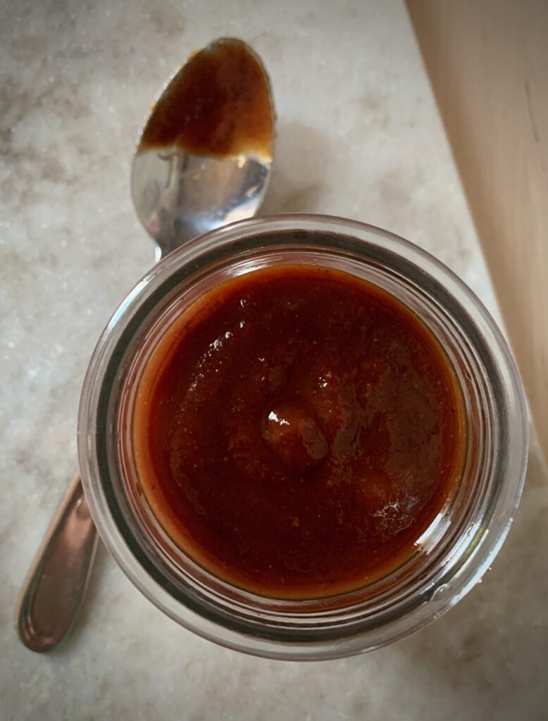 homemade bbq sauce in glass jar with spoon