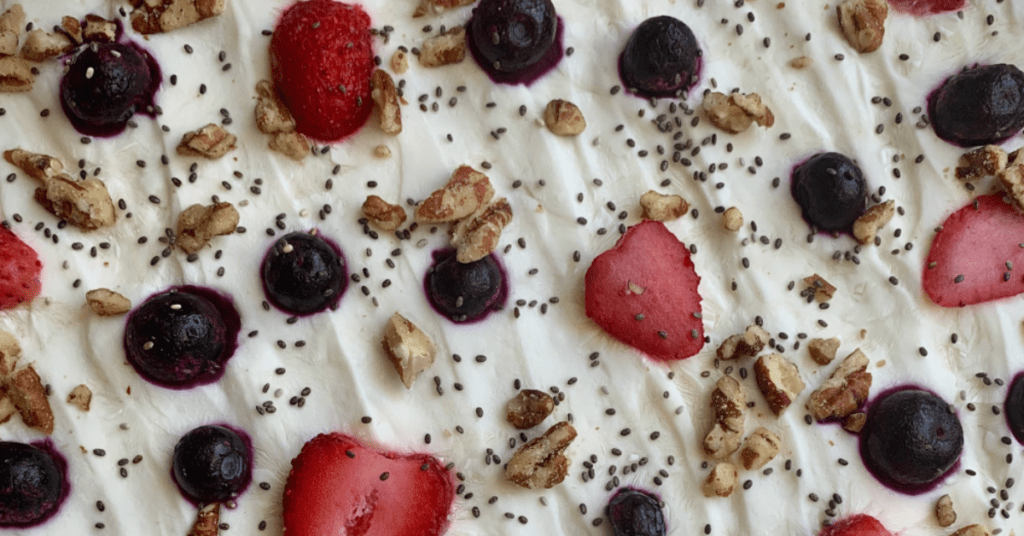 berry yogurt bark with fresh strawberries, blueberries, chopped pecans and chia seeds