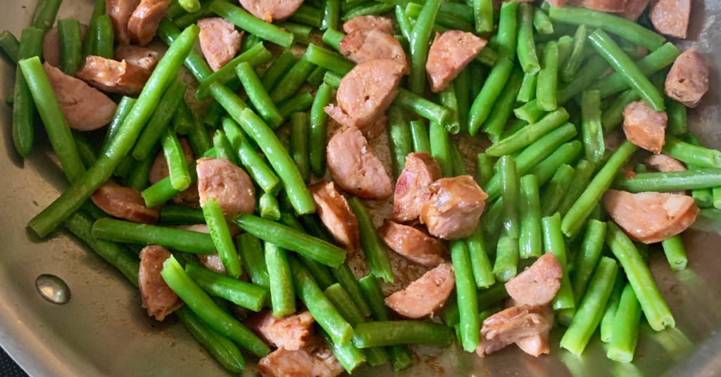 green beans and sausage in a skillet