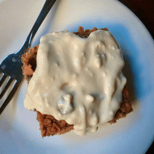 Bright red baked oatmeal made with beets and topped with an almond cream cheese topping