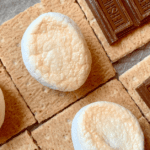 Graham crackers with toasted marshmallows and chocolate on an air fryer tray